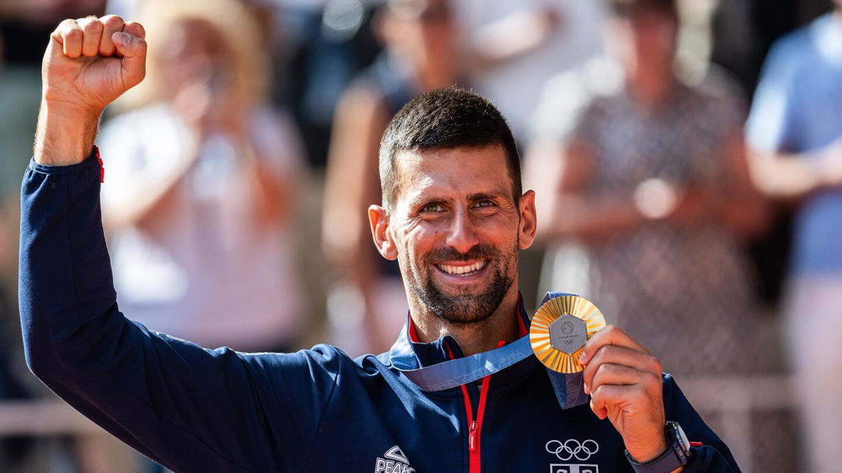 novak djokovic holds gold medal