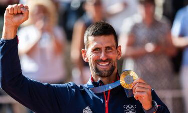 novak djokovic holds gold medal