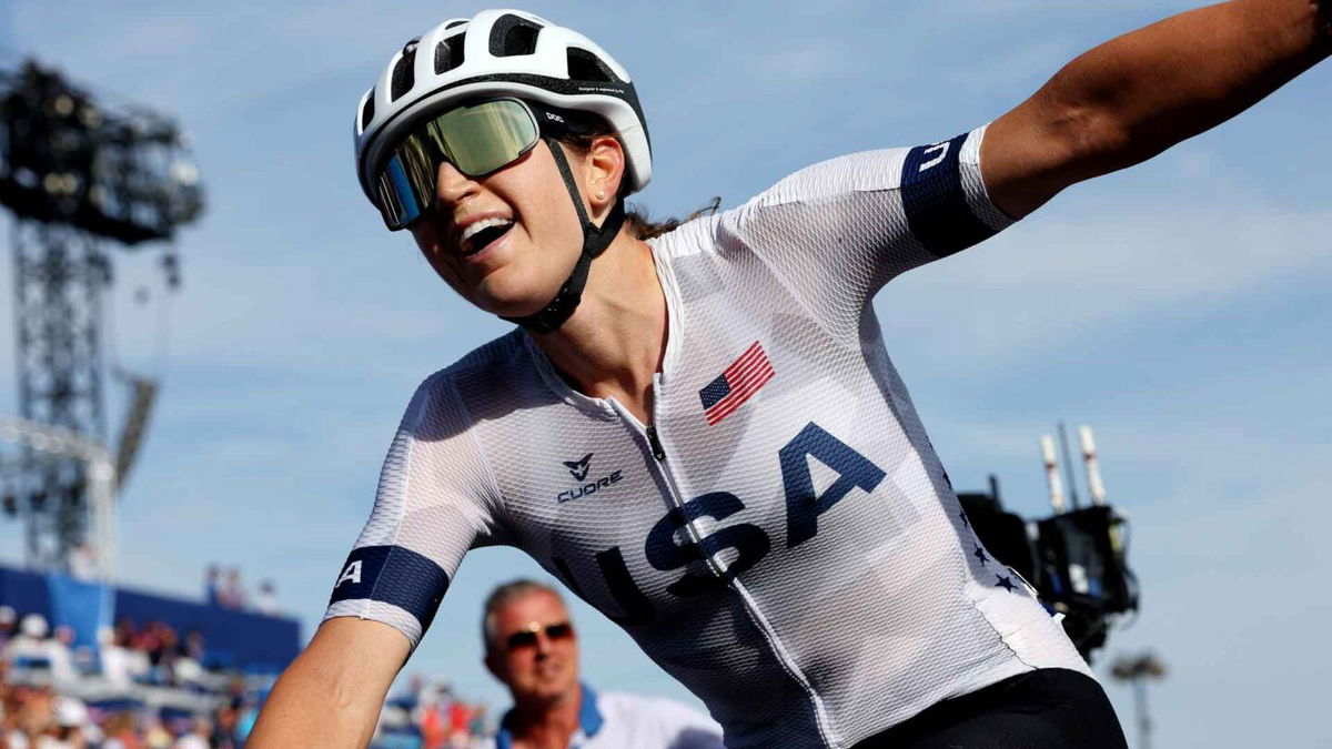 Kristen Faulkner of the United States celebrates at the finish line as gold medal winner during the women's road race on day nine of the Paris Olympics at the Trocadero on August 04