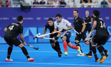 Lee Morton of Great Britain controls the ball under pressure from Germany during the men's Pool A match on day seven of the Paris Olympics at Stade Yves Du Manoir on August 02