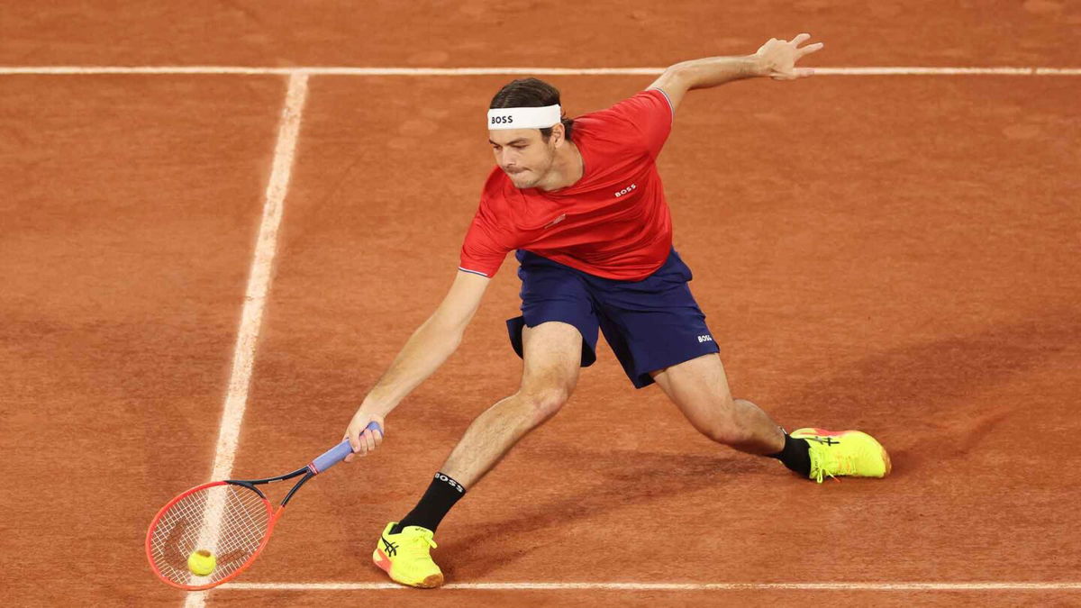 Taylor Fritz of the United States stretches for a forehand against Alexander Bublik of Kazakhstan during the men's singles first round match on day one of the Paris Olympics at Roland Garros on July 27