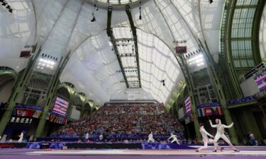 Lee Kiefer (USA) competes against Qianqian Huang (CHN) in a women's team foil table of 8 during the Paris Olympic Games at Grand Palais.