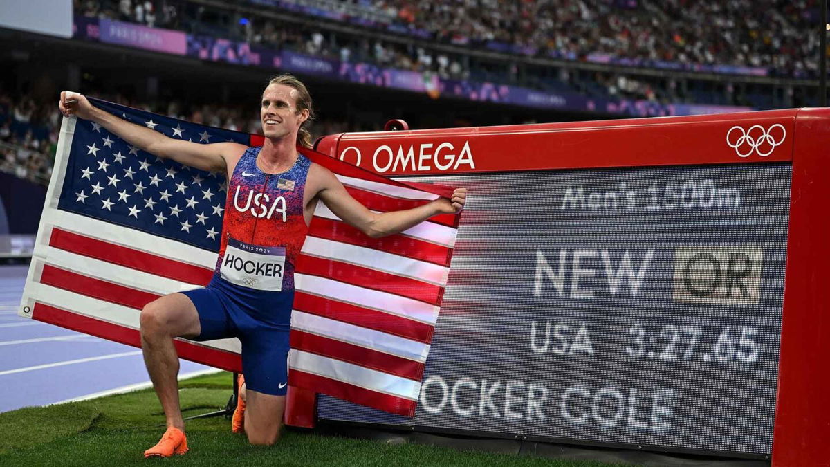 Cole Hocker of the United States poses with his new Olympic record after the men's 1500m final of track and field at the Paris Olympics on Aug. 6