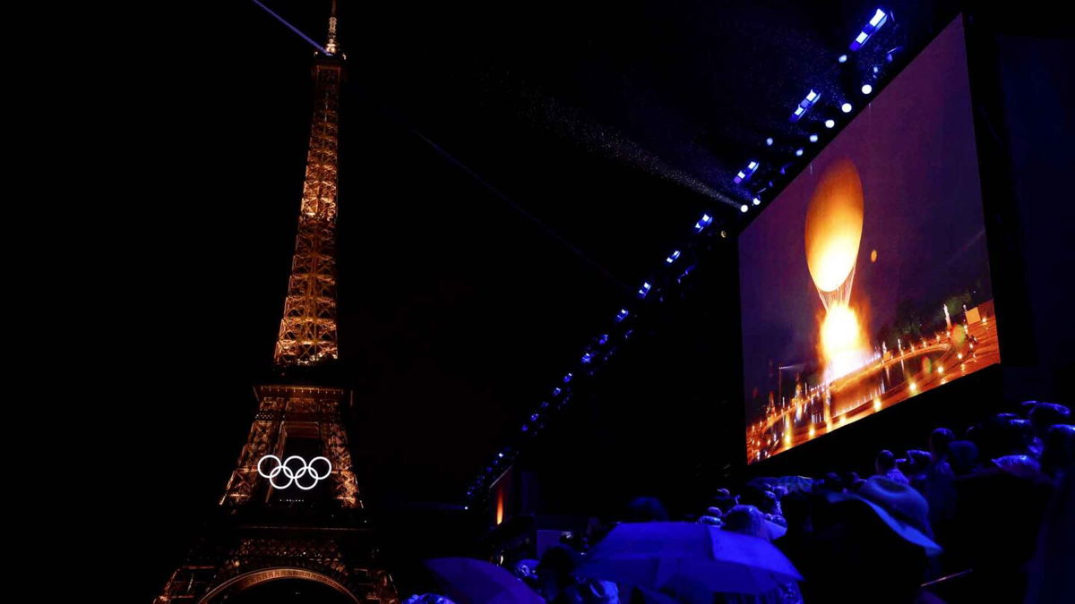 A general view of the Eiffel Tower as the Olympic Cauldron is lit on a screen during the Opening Ceremony of the 2024 Paris Olympics on July 26