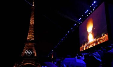 A general view of the Eiffel Tower as the Olympic Cauldron is lit on a screen during the Opening Ceremony of the 2024 Paris Olympics on July 26