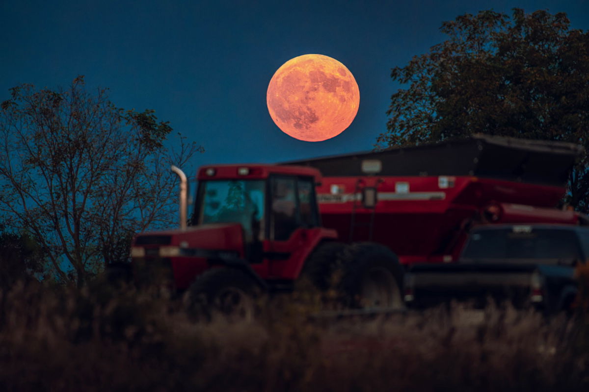 <i>Ross Harried/NurPhoto/Getty Images via CNN Newsource</i><br/>A corn supermoon rises over a soybean harvest at a farm in Monroe
