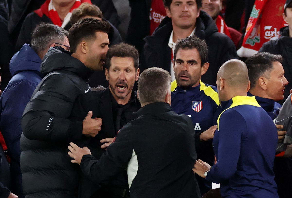 <i>Marc Atkins/Getty Images via CNN Newsource</i><br/>Diego Simeone is restrained as he confronts fans after Liverpool scores a late winner.