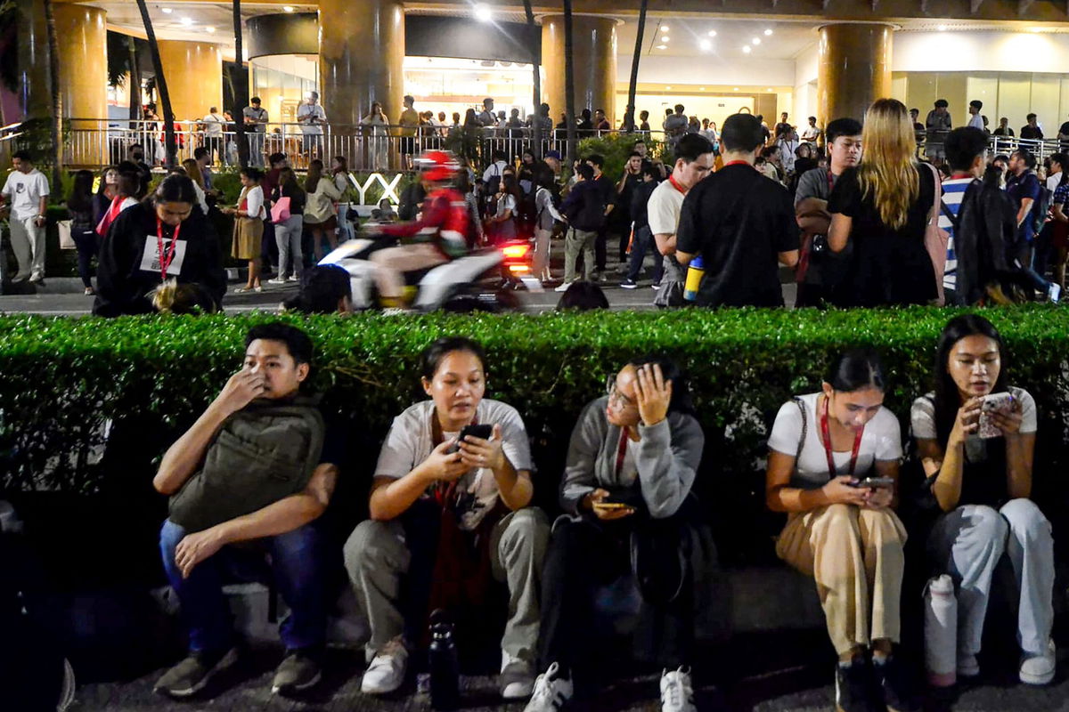 <i>Alan Tangcawan/AFP/Getty Images via CNN Newsource</i><br/>People gather on a street after earthquake tremors at Cebu in central Philippines on September 30.