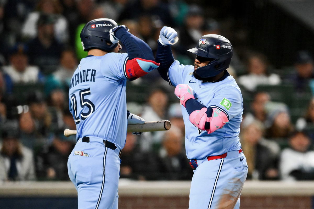 <i>Steven Bisig/Imagn Images/Reuters via CNN Newsource</i><br/>Vladimir Guerrero Jr. (right) and Anthony Santander celebrate against the Mariners.