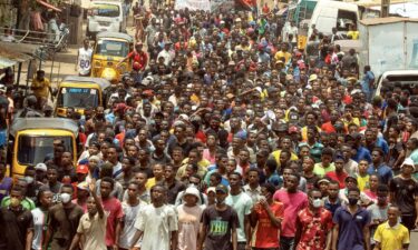 A Moroccan man holds a sign that reads
