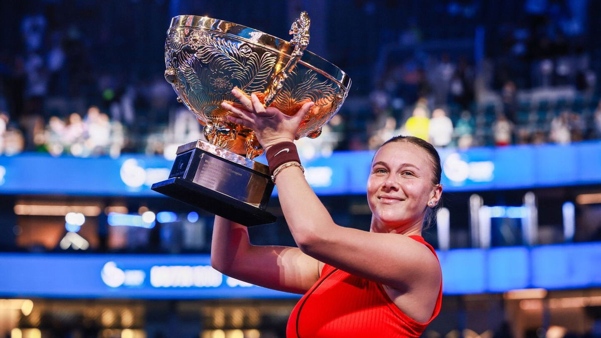 <i>China Open Official 2025/VCG/AP via CNN Newsource</i><br/>Amanda Anisimova poses with trophy during medal ceremony after winning the Women's Singles Final match against Linda Noskova.