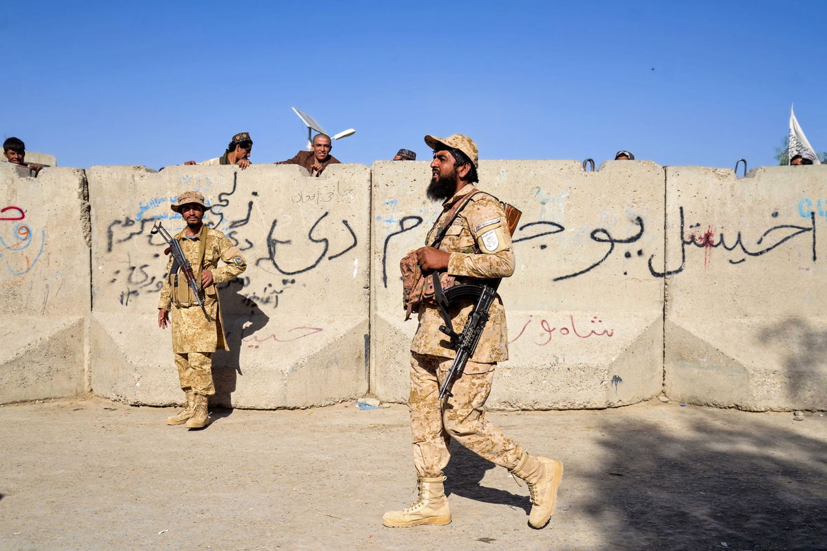 <i>Sanaullah Seiam/AFP/Getty Images via CNN Newsource</i><br/>Armed Taliban security personnel keep guard near the closed gate of the zero point border crossing between Afghanistan and Pakistan at Spin Boldak district in Kandahar province on October 12.