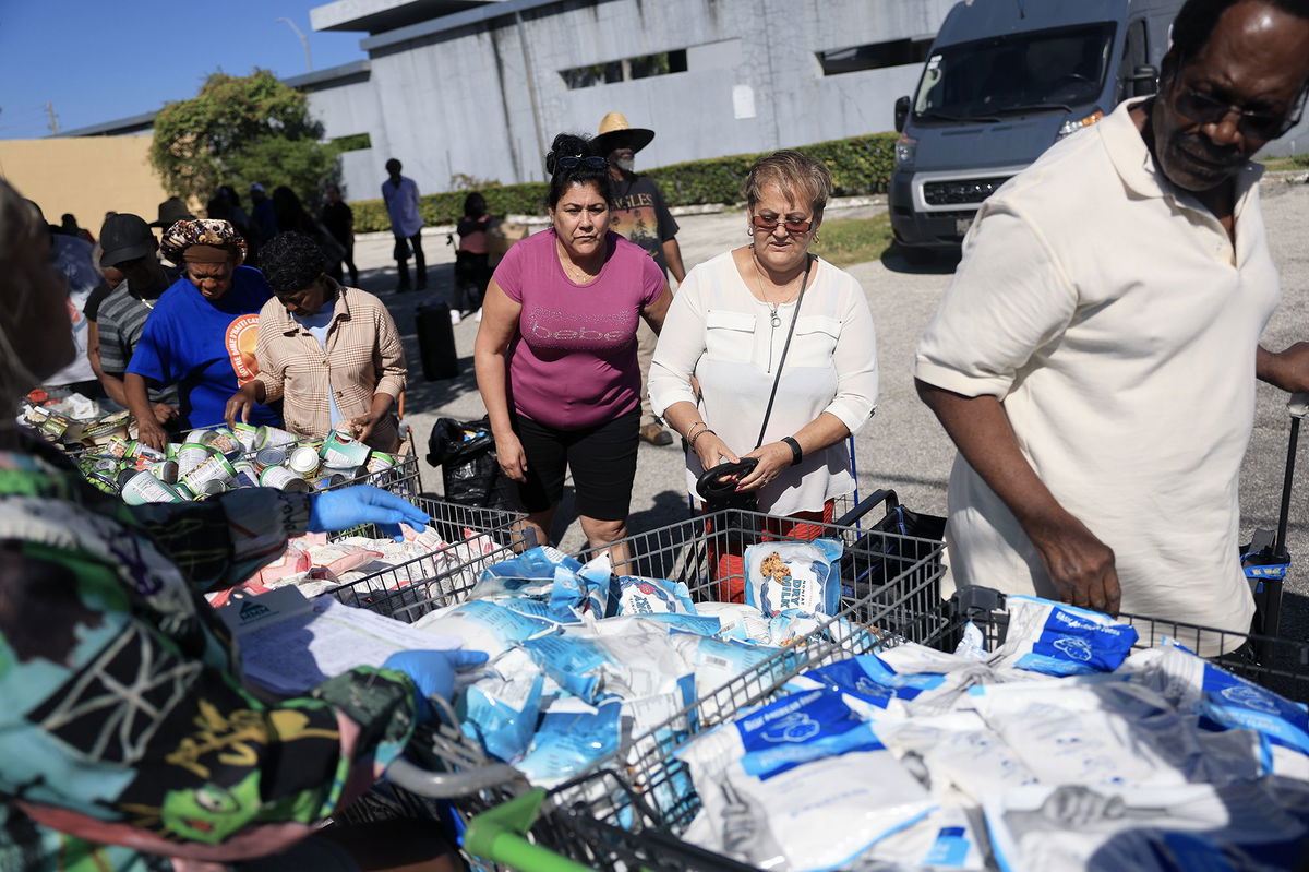 <i>Joe Raedle/Getty Images via CNN Newsource</i><br/>People receive groceries from the Curley's House Food Bank in Miami in late October. Millions of Americans may see their food stamp benefits for November delayed or skipped.