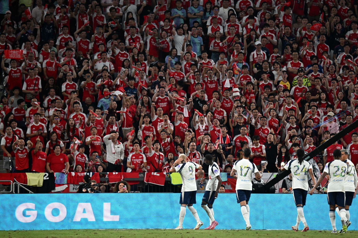 Tottenham Hotspur's players celebrate a goal in front of Arsenal fans during their friendly exhibition football match at the Kai Tak Stadium in Hong Kong on July 31.